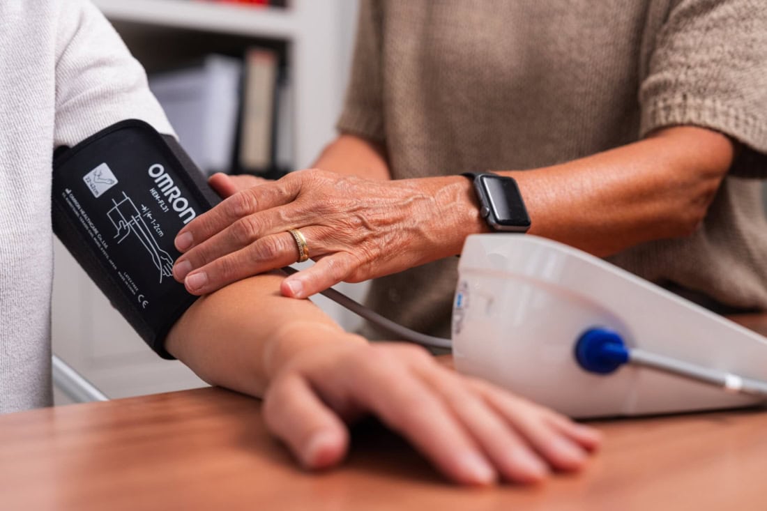 Home blood pressure measurement with digital blood pressure monitor and doctor assistance.